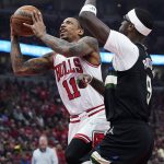
              Chicago Bulls forward DeMar DeRozan, left, drives to the basket against Milwaukee Bucks center Bobby Portis during the first half of Game 4 of a first-round NBA basketball playoff series, Sunday, April 24, 2022, in Chicago. (AP Photo/Nam Y. Huh)
            