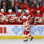 
              Calgary Flames left wing Johnny Gaudreau (13) celebrates with teammates after scoring against the Chicago Blackhawks during the first period of an NHL hockey game, Monday, April 18, 2022, in Chicago. (AP Photo/Kamil Krzaczynski)
            