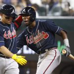 
              Atlanta Braves' William Contreras, left, celebrates with teammate Travis Demeritte after hitting a solo home run against the Texas Rangers during the fourth inning of a baseball game Friday, April 29, 2022, in Arlington, Texas. (AP Photo/Ron Jenkins)
            