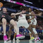 
              Louisville's Emily Engstler and South Carolina's Laeticia Amihere go after a loose ball during the first half of a college basketball game in the semifinal round of the Women's Final Four NCAA tournament Friday, April 1, 2022, in Minneapolis. (AP Photo/Eric Gay)
            