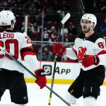 
              New Jersey Devils defenseman Kevin Bahl, right, celebrates his first NHL goal with center Michael McLeod (20) during the second period of the team's NHL hockey game against the Arizona Coyotes on Tuesday, April 12, 2022, in Glendale, Ariz. (AP Photo/Ross D. Franklin)
            