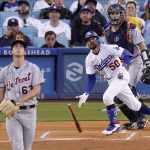 
              Los Angeles Dodgers' Mookie Betts, center, drops his bat as he hits a solo home run as Detroit Tigers starting pitcher Beau Brieske, left, watches along with catcher Dustin Garneau during the first inning of a baseball game Saturday, April 30, 2022, in Los Angeles. (AP Photo/Mark J. Terrill)
            