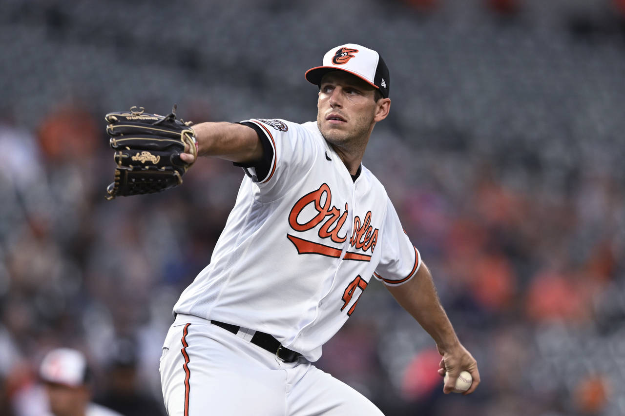 Baltimore Orioles starting pitcher John Means throws to a Milwaukee Brewers batter during the first...