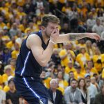 
              Dallas Mavericks guard Luka Doncic (77) reacts after being hit in the face in the second half of Game 4 of an NBA basketball first-round playoff series against the Utah Jazz Saturday, April 23, 2022, in Salt Lake City. (AP Photo/Rick Bowmer)
            