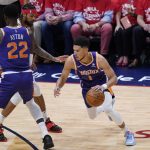 
              Phoenix Suns guard Devin Booker (1) dribbles around center Deandre Ayton (22) in the first half of game 6 of an NBA basketball first-round playoff series, Thursday, April 28, 2022 in New Orleans. (AP Photo/Gerald Herbert)
            