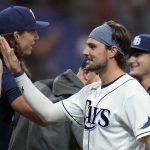 
              Tampa Bay Rays' Josh Lowe high fives teammates afater the team defeated the Minnesota Twins during a baseball game Friday, April 29, 2022, in St. Petersburg, Fla. (AP Photo/Chris O'Meara)
            