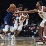 
              Brooklyn Nets guard Kyrie Irving (11) drives past Cleveland Cavaliers center Evan Mobley (4) during the second half of an NBA basketball game Friday April 8, 2022, in New York. (AP Photo/Bebeto Matthews)
            
