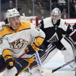 
              Nashville Predators center Philip Tomasino, front left, looks to pass the puck as Colorado Avalanche left wing J.T. Compher, right, and goaltender Darcy Kuemper defend during the second period of an NHL hockey game Thursday, April 28, 2022, in Denver. (AP Photo/David Zalubowski)
            