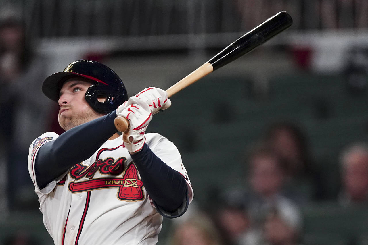 Atlanta Braves' Austin Riley (27) follows throw after hitting a two-run home run in the eighth inni...