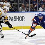 
              New York Islanders left wing Anthony Beauvillier (18) and Pittsburgh Penguins left wing Brock McGinn (23) battle for the puck in the second period of an NHL hockey game, Tuesday, April 12, 2022, in Elmont, N.Y. (AP Photo/Adam Hunger)
            