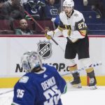 
              Vegas Golden Knights' Shea Theodore (27) celebrates after scoring against Vancouver Canucks goalie Thatcher Demko (35) during overtime in an NHL hockey game Sunday, April 3, 2022, in Vancouver, British Columbia. (Darryl Dyck/The Canadian Press via AP)
            