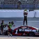 
              Ross Chastain, top, celebrates by slamming a watermelon to the ground after winning a NASCAR Cup Series auto race Sunday, April 24, 2022, in Talladega, Ala. (AP Photo/Skip Williams)
            