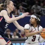 
              South Carolina's Destanni Henderson tries to get past UConn's Paige Bueckers during the first half of a college basketball game in the final round of the Women's Final Four NCAA tournament Sunday, April 3, 2022, in Minneapolis. (AP Photo/Charlie Neibergall)
            
