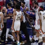 
              Phoenix Suns guard Landry Shamet (14) pushes New Orleans Pelicans guard Jose Alvarado as he and teammates tend to forward Cameron Johnson after he was fouled in the first half of game 6 of an NBA basketball first-round playoff series, Thursday, April 28, 2022 in New Orleans. (AP Photo/Gerald Herbert)
            