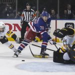 
              A shot by New York Rangers center Jonny Brodzinski (76) is blocked by Pittsburgh Penguins goaltender Tristan Jarry, right, during the second period of an NHL hockey game Thursday, April 7, 2022, in New York. (AP Photo/Bebeto Matthews)
            