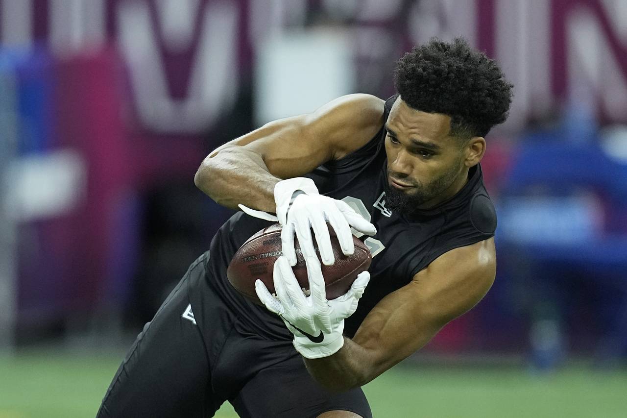 FILE - Ohio State wide receiver Chris Olave runs a drill during the NFL football scouting combine, ...
