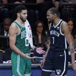 
              Brooklyn Nets forward Kevin Durant (7) and Boston Celtics forward Jayson Tatum (0) during a Celtics foul challenge during the second half of Game 3 of an NBA basketball first-round playoff series, Saturday, April 23, 2022, in New York. (AP Photo/John Minchillo)
            