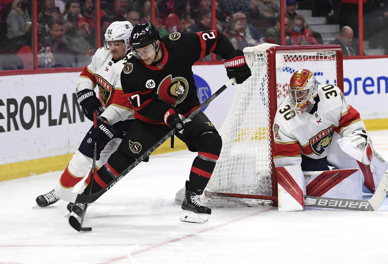 Florida Panthers defenceman Lucas Carlsson (32) passes the puck out of the reach of Ottawa Senators...
