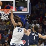 
              Minnesota Timberwolves center Karl-Anthony Towns (32) is fouled as he shoots against Memphis Grizzlies forward Kyle Anderson (1) in the first half during Game 5 of a first-round NBA basketball playoff series Tuesday, April 26, 2022, in Memphis, Tenn. (AP Photo/Brandon Dill)
            