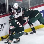 
              Arizona Coyotes' Loui Eriksson (21) is double-teamed by Minnesota Wild's Ryan Hartman, left, and Dmitry Kulikov in the first period of an NHL hockey game, Tuesday, April 26, 2022, in St. Paul, Minn. (AP Photo/Jim Mone)
            