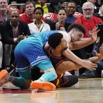 
              Charlotte Hornets guard LaMelo Ball, top, and Atlanta Hawks guard Timothe Luwawu-Cabarrot go for the ball during the first half of an NBA play-in basketball game Wednesday, April 13, 2022, in Atlanta. (AP Photo/John Bazemore)
            