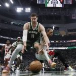 
              Milwaukee Bucks' Brook Lopez and Chicago Bulls' DeMar DeRozan go for a loose ball during the first half of Game 5 of an NBA basketball first-round playoff series Wednesday, April 27, 2022, in Milwaukee. (AP Photo/Morry Gash)
            