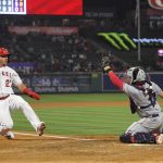
              Los Angeles Angels' Mike Trout, left, slides before being tagged out at home by Cleveland Guardians catcher Austin Hedges while trying to score on a double by Jared Walsh during the eighth inning of a baseball game Tuesday, April 26, 2022, in Anaheim, Calif. (AP Photo/Mark J. Terrill)
            