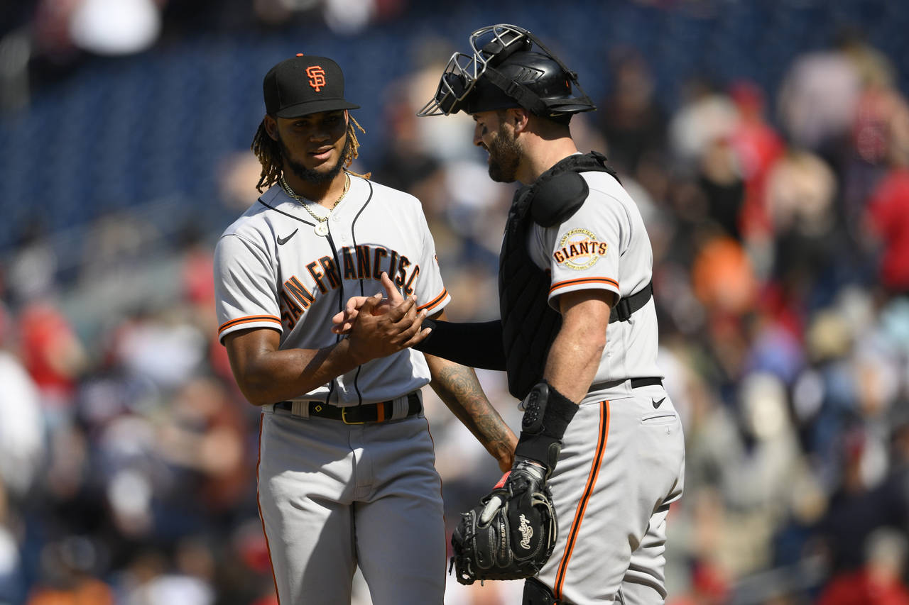 San Francisco Giants relief pitcher Camilo Doval, left, and catcher Curt Casali celebrate after a b...