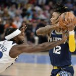 
              Memphis Grizzlies guard Ja Morant (12) tries to keep the ball from Minnesota Timberwolves guard Patrick Beverley (22) during the first half during Game 2 of a first-round NBA basketball playoff series Tuesday, April 19, 2022, in Memphis, Tenn. (AP Photo/Brandon Dill)
            