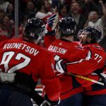 
              Washington Capitals defenseman John Carlson celebrates his goal with right wing T.J. Oshie (77) and center Evgeny Kuznetsov (92) during the second period of the team's NHL hockey game against the Tampa Bay Lightning, Wednesday, April 6, 2022, in Washington. (AP Photo/Nick Wass)
            