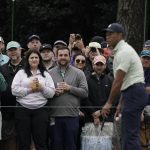 
              Spectators watch Tiger Woods on the driving range during a practice round for the Masters golf tournament on Tuesday, April 5, 2022, in Augusta, Ga. (AP Photo/Charlie Riedel)
            