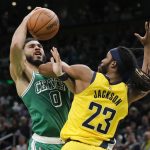 
              Indiana Pacers' Isaiah Jackson (23) fouls Boston Celtics' Jayson Tatum (0) during the first half of an NBA basketball game Friday, April 1, 2022, in Boston. (AP Photo/Michael Dwyer)
            