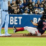 
              Boston Red Sox's Xander Bogaerts (2) slides safely into third base during fourth-inning baseball game action against the Toronto Blue Jays in Toronto, Monday, April 25, 2022. (Christopher Katsarov/The Canadian Press via AP)
            