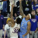 
              Kansas guard Ochai Agbaji (30) shoots over North Carolina forward Armando Bacot (5) during the second half of a college basketball game in the finals of the Men's Final Four NCAA tournament, Monday, April 4, 2022, in New Orleans. (AP Photo/Gerald Herbert)
            