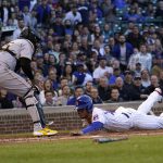 
              Chicago Cubs' Willson Contreras scores on a sacrifice fly by Jonathan Villar, as Pittsburgh Pirates catcher Roberto Perez waits for the throw during the first inning of a baseball game Thursday, April 21, 2022, in Chicago. (AP Photo/Charles Rex Arbogast)
            