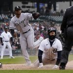 
              Detroit Tigers' Javier Baez is tagged out by Chicago White Sox starting pitcher Reynaldo Lopez (40) during the sixth inning of a baseball game, Saturday, April 9, 2022, in Detroit. (AP Photo/Carlos Osorio)
            