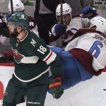 
              Minnesota Wild's Jordan Greenway (18) checks Colorado Avalanche's Erik Johnson (6 ) into the Wild bench in the second period of an NHL hockey game Friday, April 29, 2022, in St. Paul, Minn. (AP Photo/Jim Mone)
            