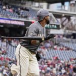 
              Washington Nationals designated hitter Nelson Cruz tosses his bat as he watches his solo home run during the first inning of a baseball game against the New York Mets at Nationals Park, Sunday, April 10, 2022, in Washington, D.C. (AP Photo/Alex Brandon)
            
