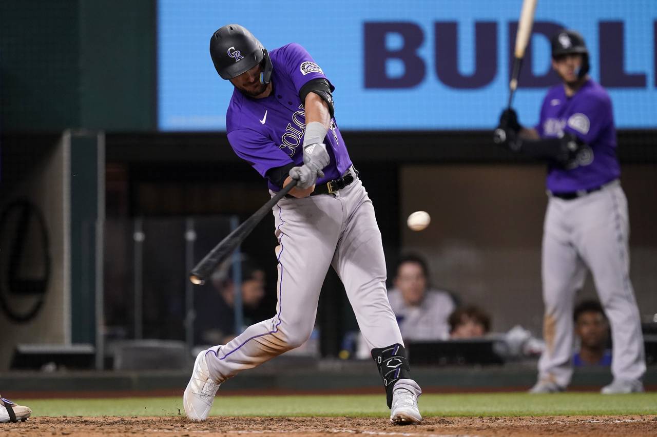 Colorado Rockies' Kris Bryant connects for a sacrifice fly that scored Connor Joe in the seventh in...