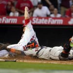 
              Los Angeles Angels' Jared Walsh, left, is tagged out at home plate by Houston Astros catcher Martin Maldonado as Walsh tried to score on a single by Brandon Marsh during the first inning of a baseball game Friday, April 8, 2022, in Anaheim, Calif. (AP Photo/Marcio Jose Sanchez)
            