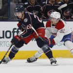 
              Columbus Blue Jackets' Jake Bean, left, carries the puck past Montreal Canadiens' Rem Pitlick during the second period of an NHL hockey game Wednesday, April 13, 2022, in Columbus, Ohio. (AP Photo/Jay LaPrete)
            