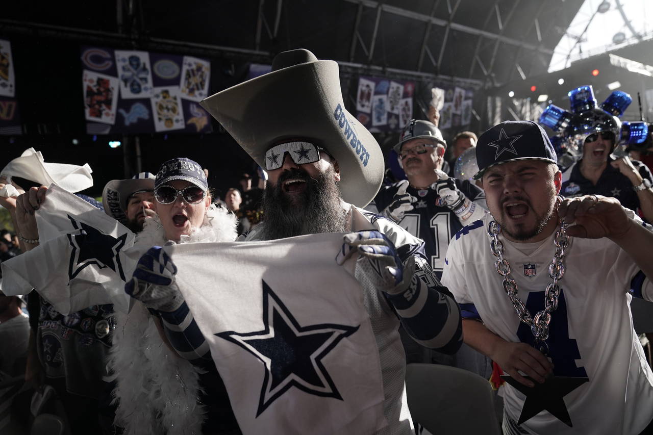 Dallas Cowboys fan cheer during the second round of the NFL football draft Friday, April 29, 2022, ...