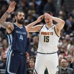 
              Denver Nuggets center Nikola Jokic, right, pulls on a headband for protection after he took a hit to the right temple that drew blood during the first half of an NBA basketball game Thursday, April 7, 2022, in Denver. Memphis Grizzlies' Steven Adams is at left. (AP Photo/David Zalubowski)
            
