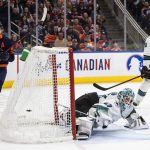 
              San Jose Sharks goalie James Reimer, center, is scored against as Edmonton Oilers' Ryan Nugent-Hopkins (93) watches the puck go into the net during overtime NHL hockey game action in Edmonton, Alberts, Thursday, April 28, 2022. (Jason Franson/The Canadian Press via AP)
            