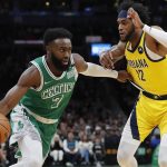 
              Boston Celtics' Jaylen Brown (7) drives past Indiana Pacers' Oshae Brissett (12) during the first half of an NBA basketball game Friday, April 1, 2022, in Boston. (AP Photo/Michael Dwyer)
            