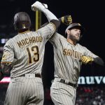 
              San Diego Padres' Austin Nola, right, is congratulated by Manny Machado after hitting a solo home run against the San Francisco Giants during the fifth inning of a baseball game in San Francisco, Monday, April 11, 2022. (AP Photo/Jeff Chiu)
            
