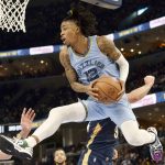 
              Memphis Grizzlies guard Ja Morant (12) handles the ball under the basket during the second half of the team's NBA basketball game against the New Orleans Pelicans onSaturday, April 9, 2022, in Memphis, Tenn. (AP Photo/Brandon Dill)
            