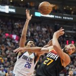 
              Dallas Mavericks guard Spencer Dinwiddie (26) loses control of the ball defended by Utah Jazz center Rudy Gobert (27) in the first half of Game 6 of an NBA basketball first-round playoff series, Thursday, April 28, 2022, in Salt Lake City. (AP Photo/Rick Bowmer)
            