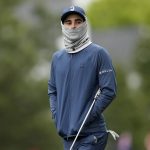 
              Joaquin Niemann, of Chile, wears a neck gaiter to protect himself from the cold on the first fairway during the third round at the Masters golf tournament on Saturday, April 9, 2022, in Augusta, Ga. (AP Photo/David J. Phillip)
            