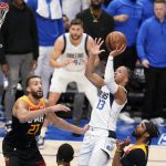 
              Utah Jazz center Rudy Gobert (27) and Mike Conley, right, defend as Dallas Mavericks guard Jalen Brunson (13) shoots in the second half of Game 2 of an NBA basketball first-round playoff series, Monday, April 18, 2022, in Dallas. (AP Photo/Tony Gutierrez)
            
